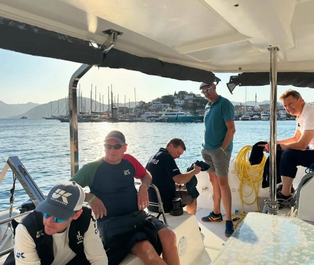 UK Sailmakers group relaxing in a sailboat cockpit at a Turkish harbor