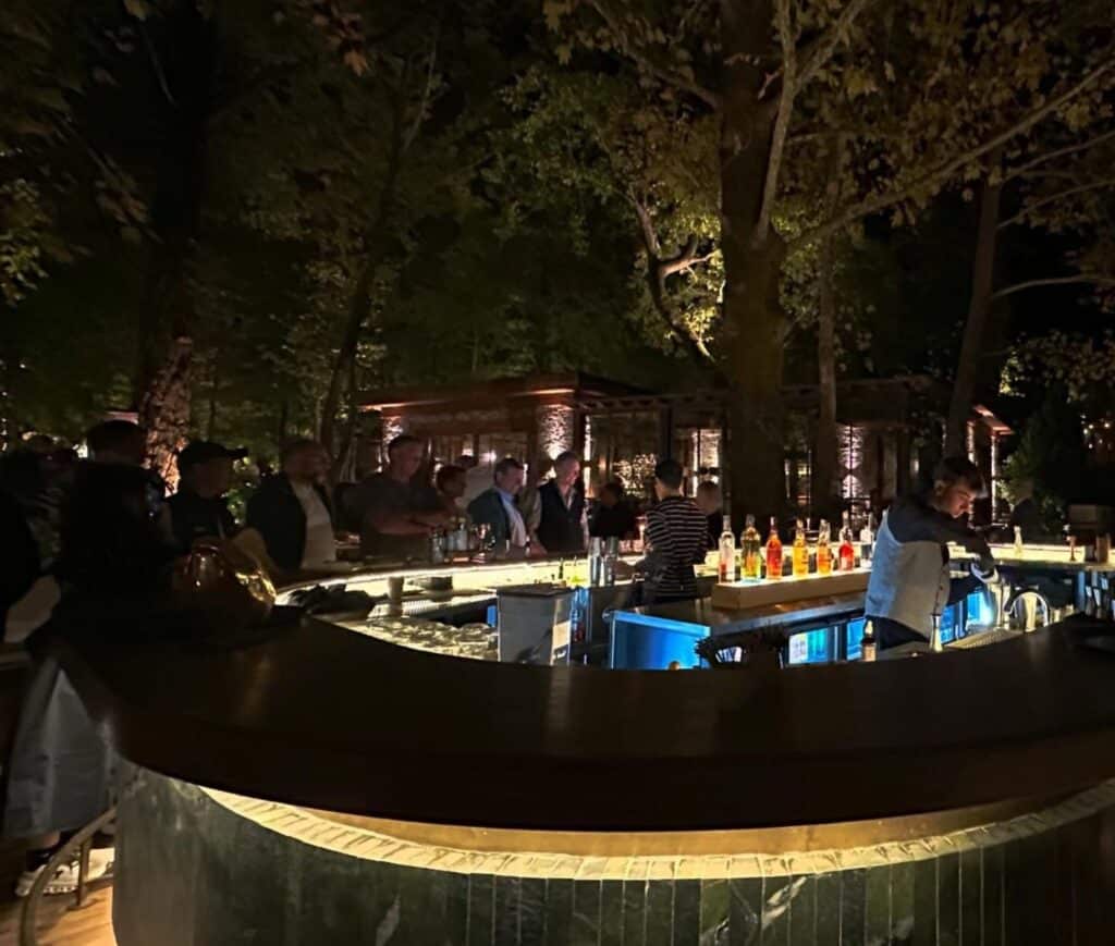Evening reception at an outdoor bar under trees during the Türkiye meeting