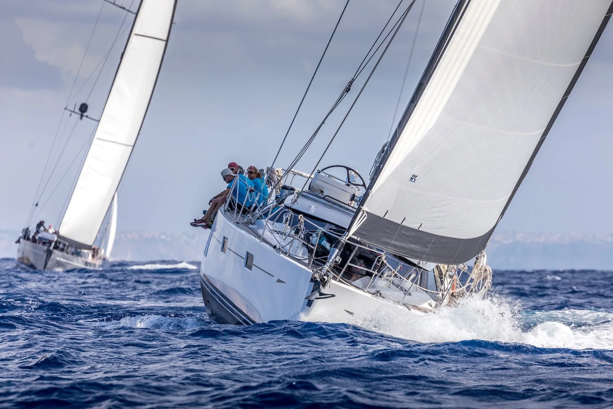 Oyster 575 heeled hard under X-Drive® sails, spray flying off the bow