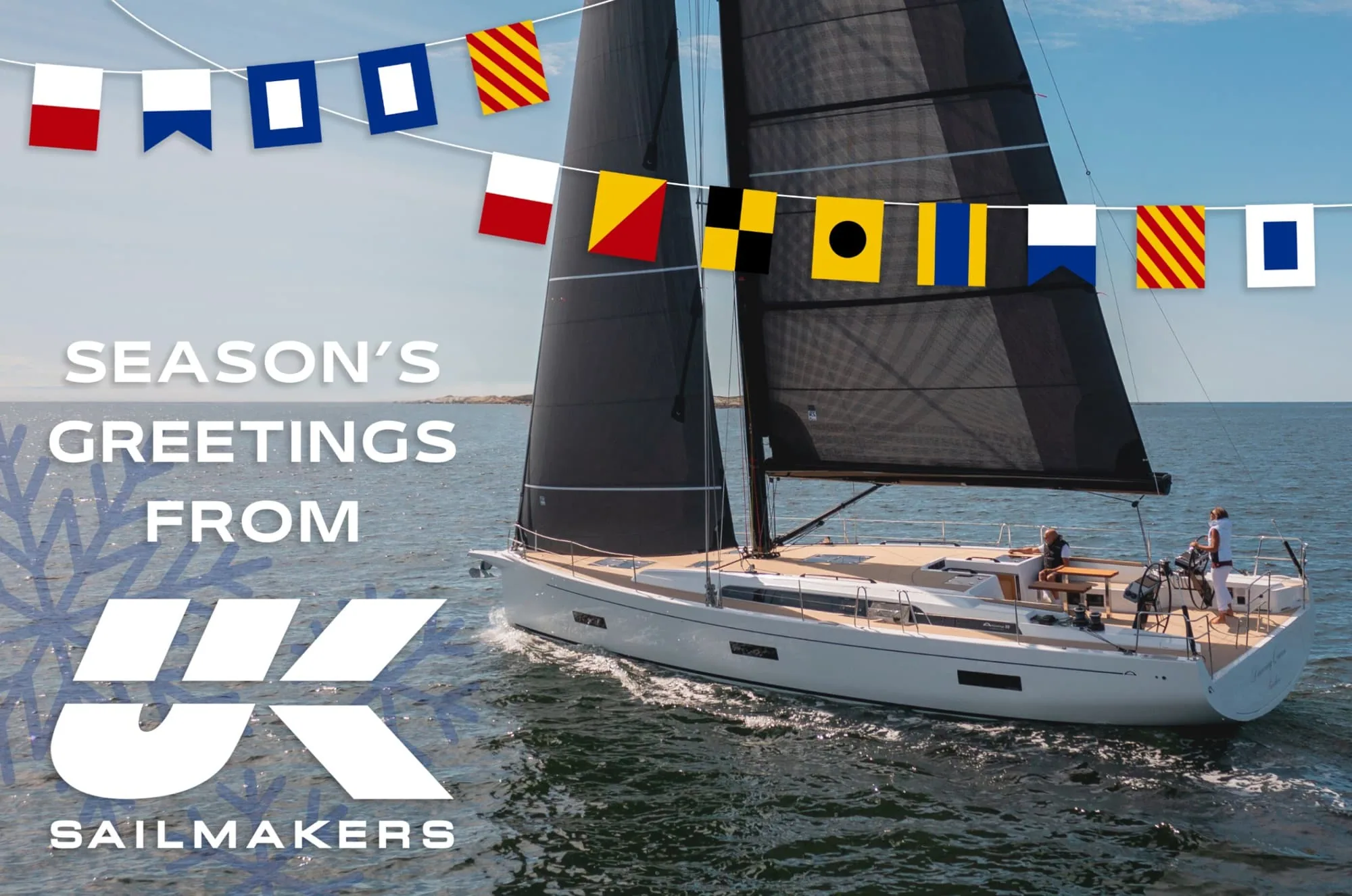 “Season’s Greetings from UK Sailmakers” graphic with a black-sailed yacht