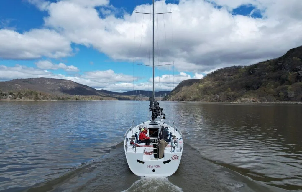 SOULMATES motoring bow-on toward the camera on a wide river