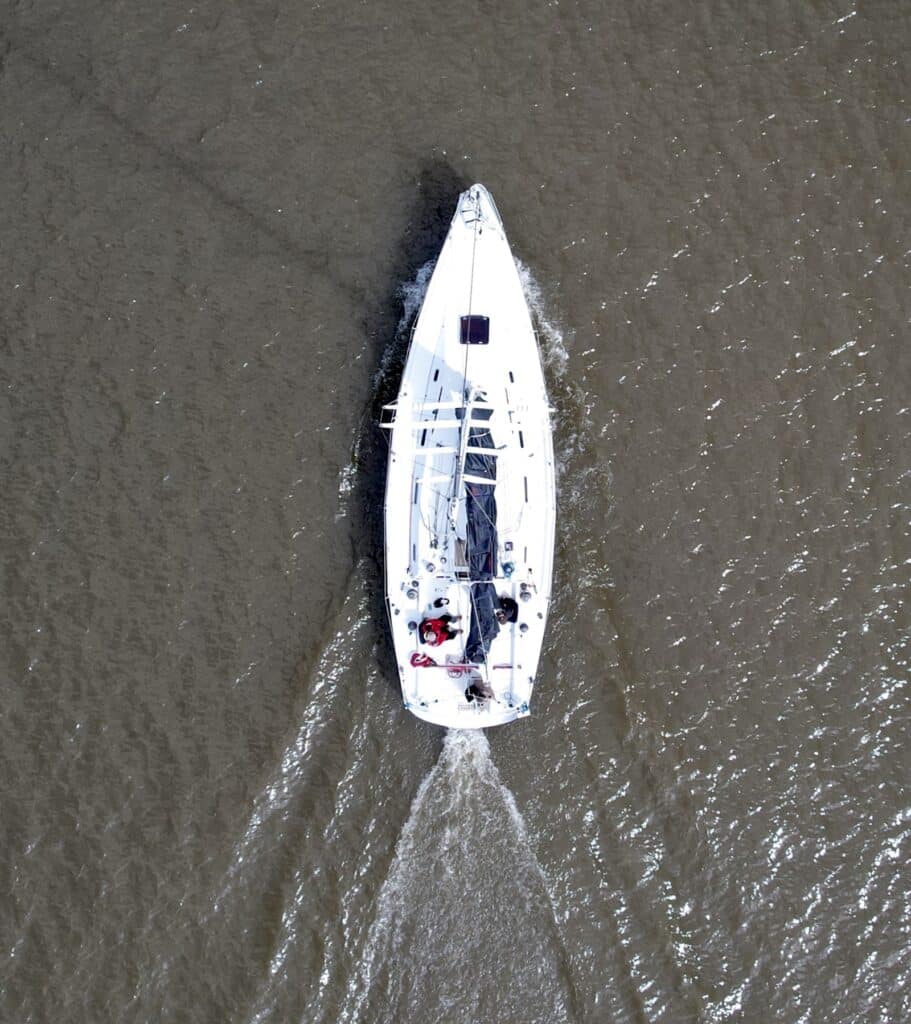 Close aerial view of SOULMATES's deck layout underway, wake trailing behind