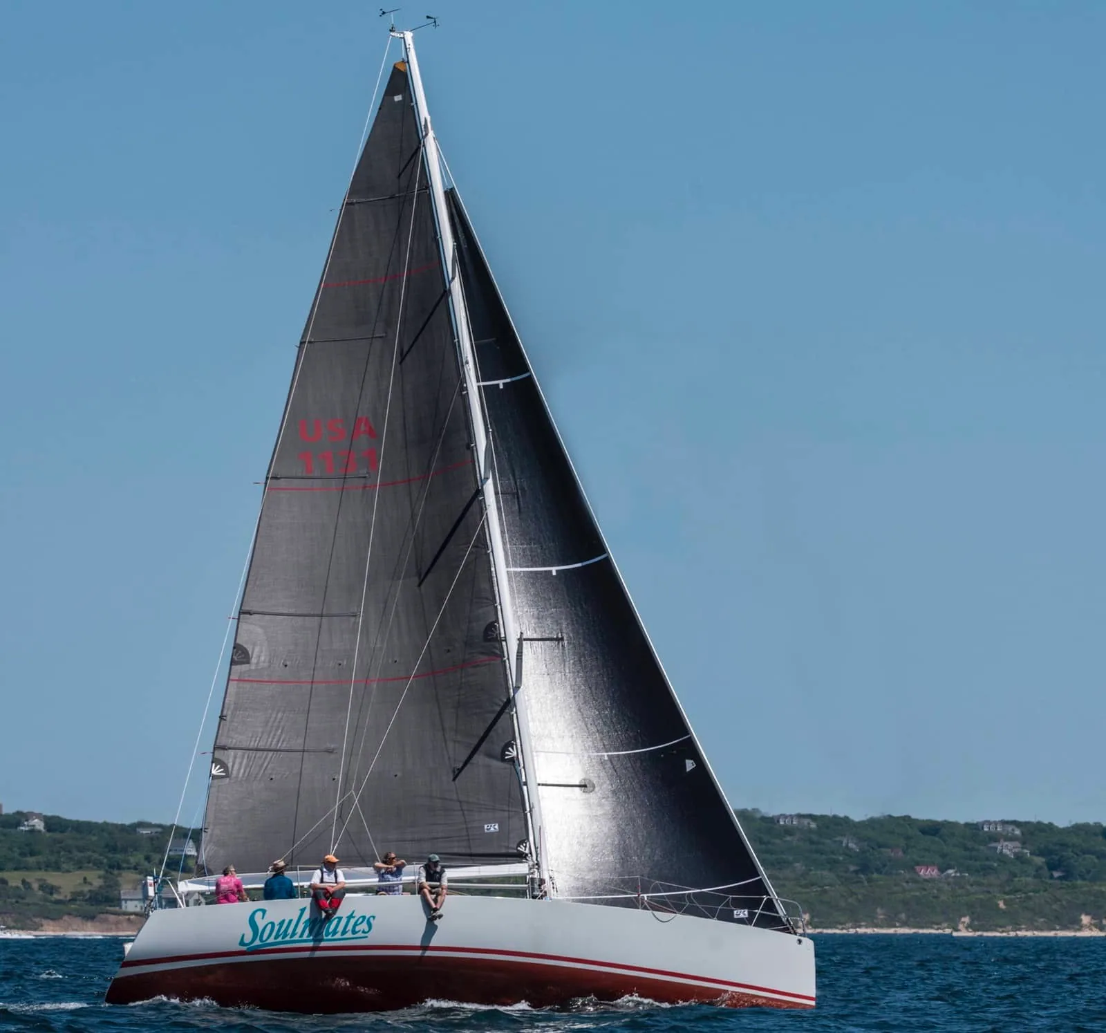 SOULMATES sailing under a dark mainsail and jib, heeled to leeward