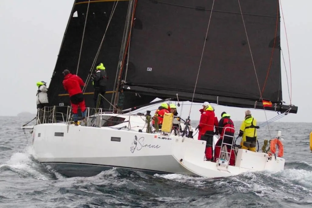 SIRENE reaching hard under a dark mainsail during an offshore race