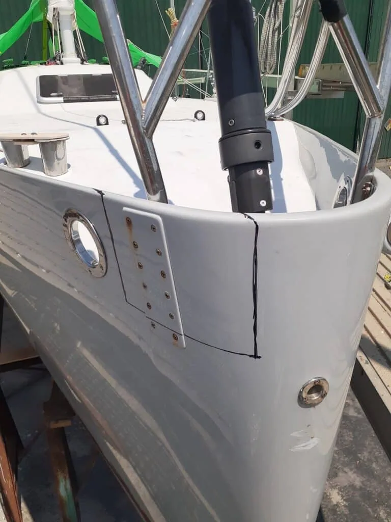 Boat hull marked with cut lines for a hatch modification during a refit