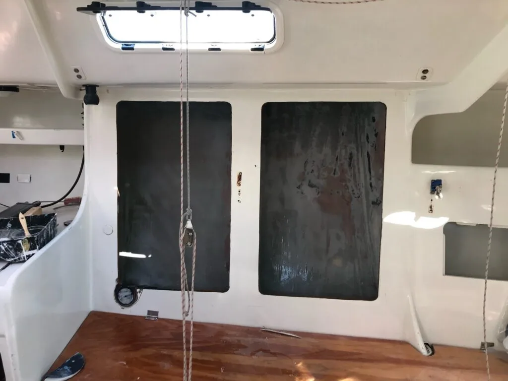 New dark access panels cut into the settee sides on either side of the mast for water ballast tanks
