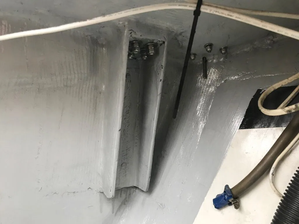 Running backstay chainplate reinforcement bolted through the hull, wiring routed alongside