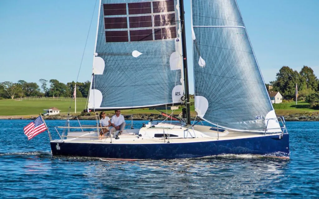 J/88 sailing under UK Sailmakers Titanium BLUE Power Sails with an American flag flying