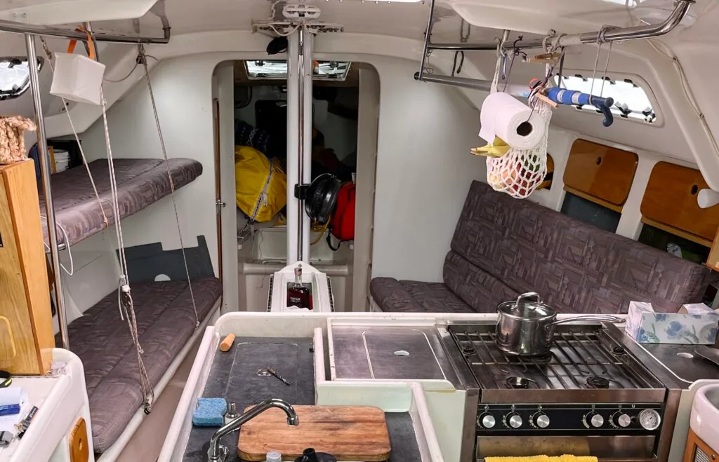 SOULMATES's saloon showing settee bunks, galley stove, and companionway looking forward