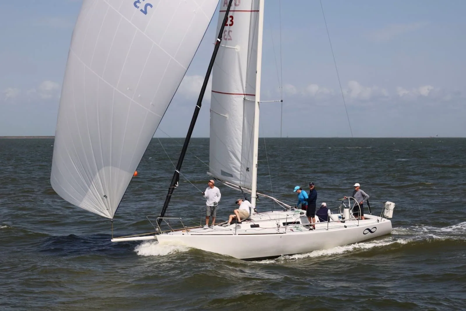 J/105 flying a spinnaker and mainsail, sail number 23, during the J/105 Invitational