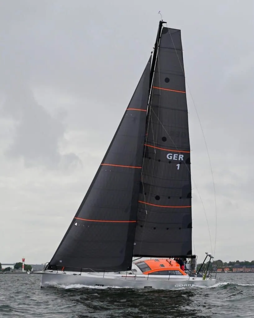 Ocean racer GER 1 with bold white sail numbers on black sails and an orange cockpit
