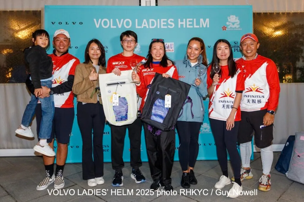Group of sailors and family posing with trophies and bags at the Volvo Ladies Helm