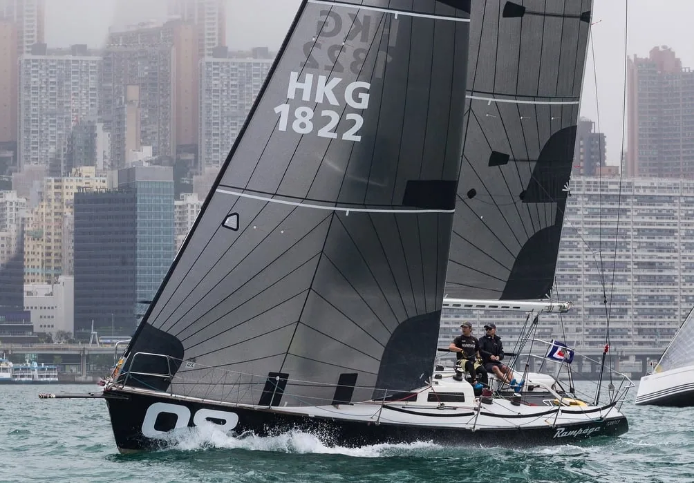Tripp 40 RAMPAGE (HKG 1822) racing under tri-radial sails off the Hong Kong skyline