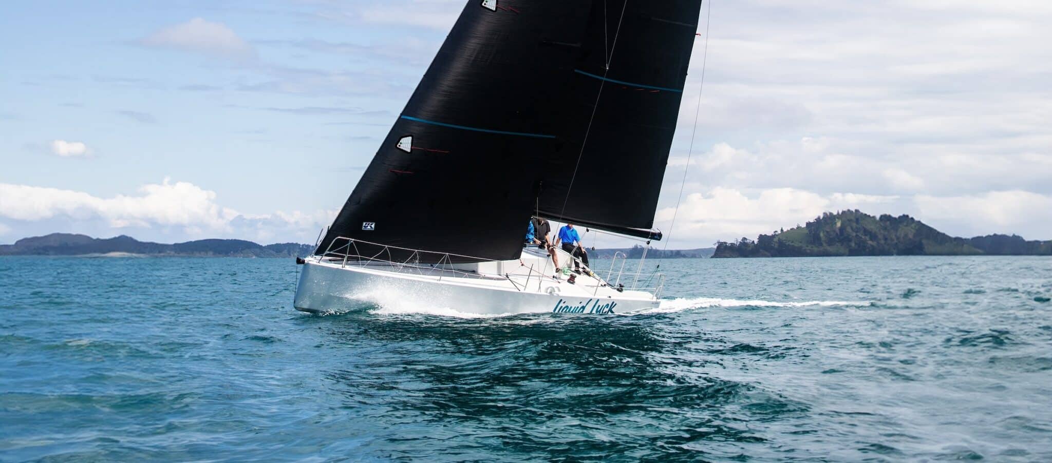 Elliott 30 Liquid Luck reaching under a black Titanium mainsail off New Zealand