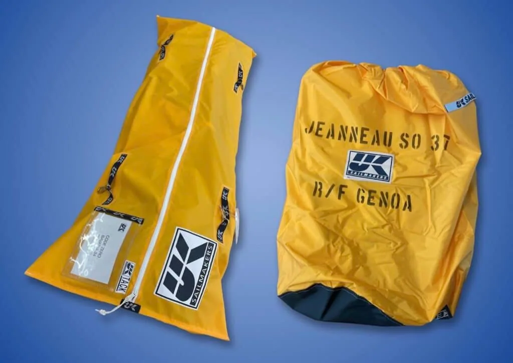 Example of two different labelling styles for UK Sailmakers bags. There’s a laminated card in a pouch on the code zero sausage bag (left) and stenciled label on a drawstring style bag (right).