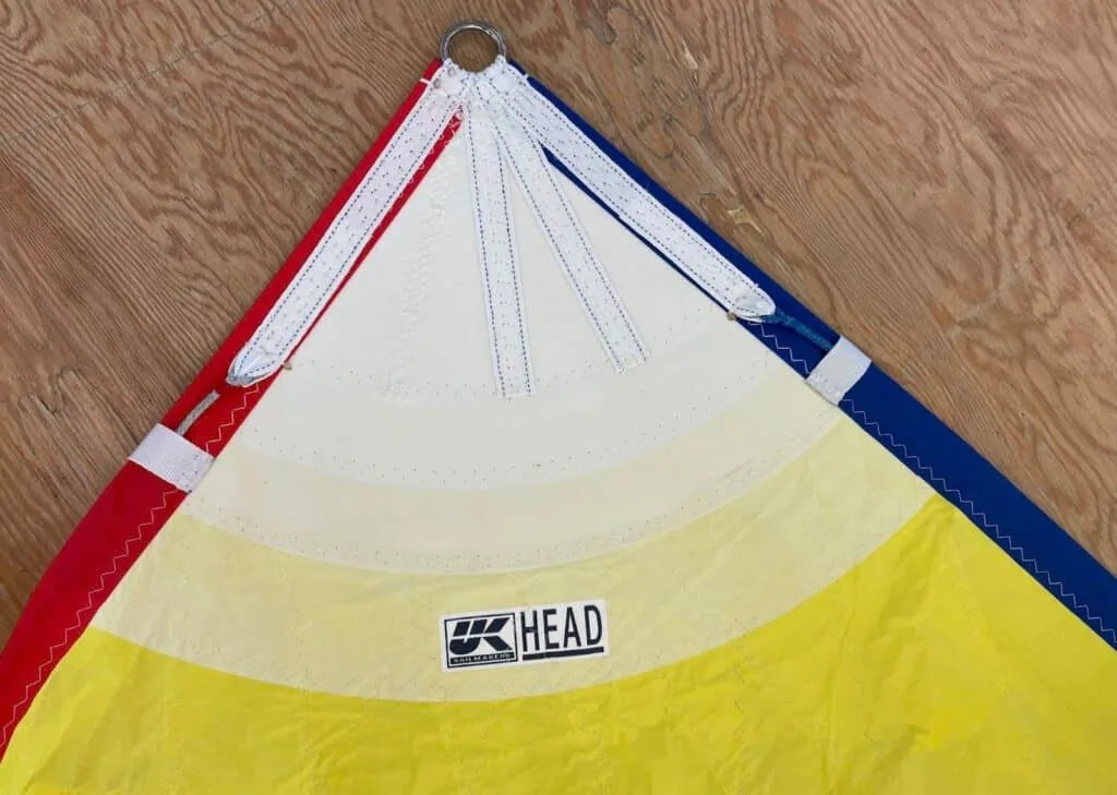 An asymmetrical spinnaker with a UK Sailmakers corner label.