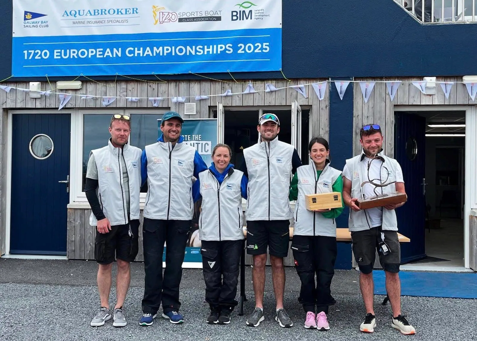 Spiced Beef crew poses with trophy under the 1720 European Championships banner