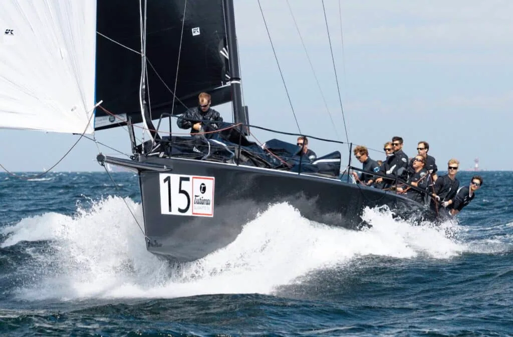 Grand-prix racer 15 powers upwind with crew hiked out hard