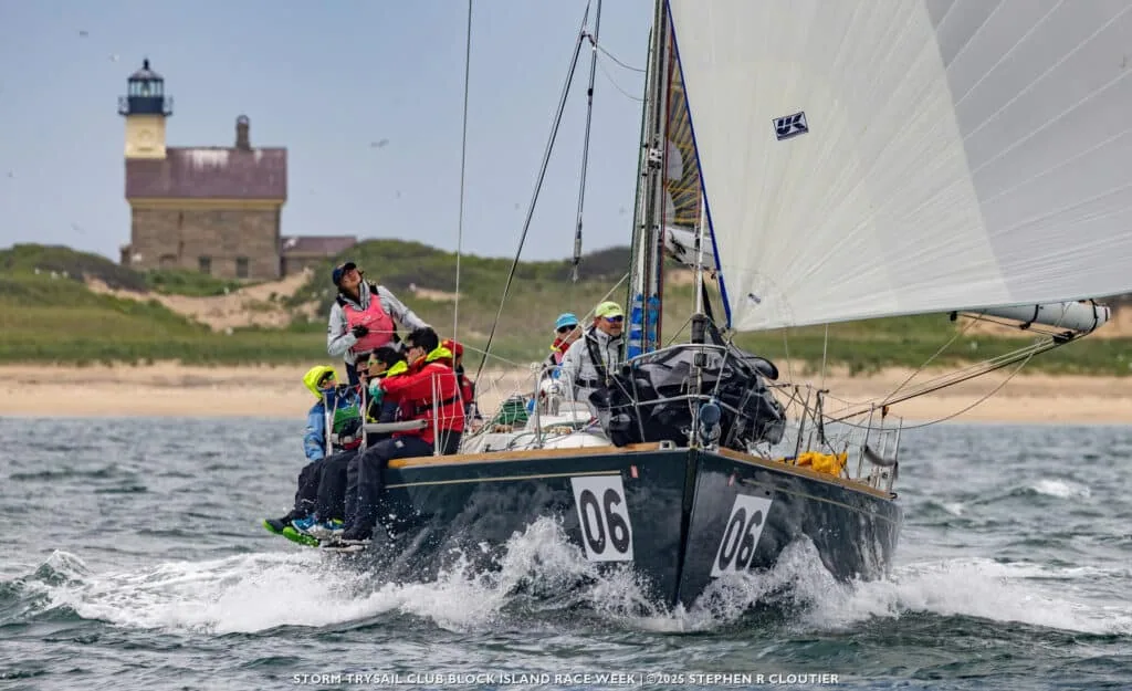 Boat 06 races past a Block Island lighthouse during Block Island Race Week