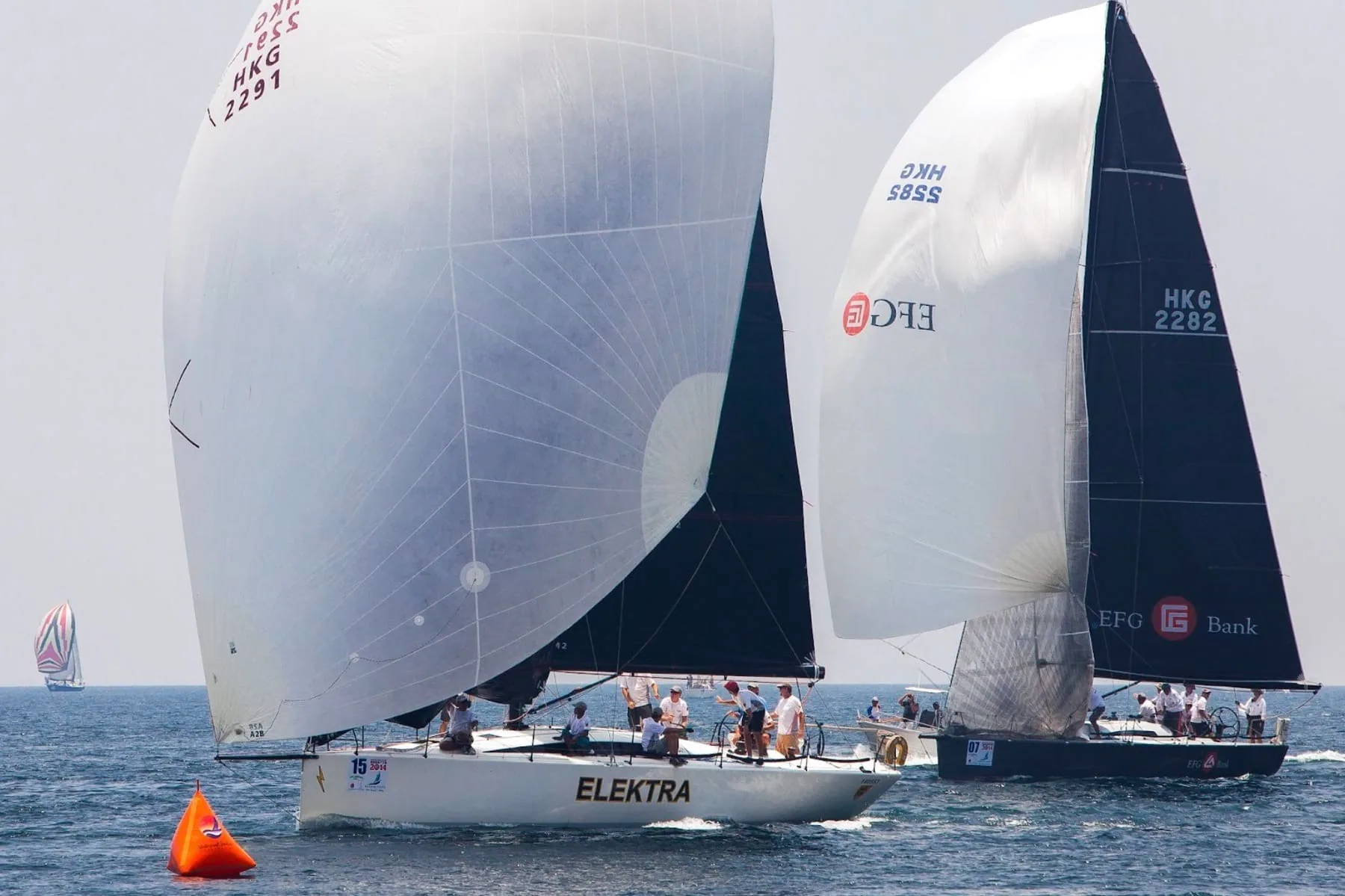 Elektra and an EFG-sponsored yacht round a mark during a spinnaker takedown