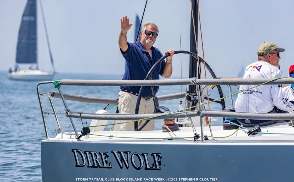 Dire Wolf's skipper waves from the helm at Block Island Race Week