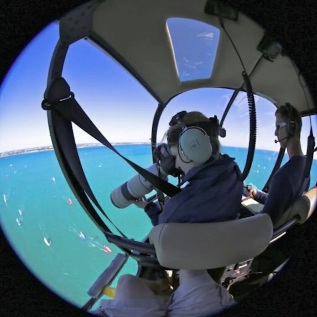 Fisheye view from a helicopter cockpit as a photographer shoots the fleet below