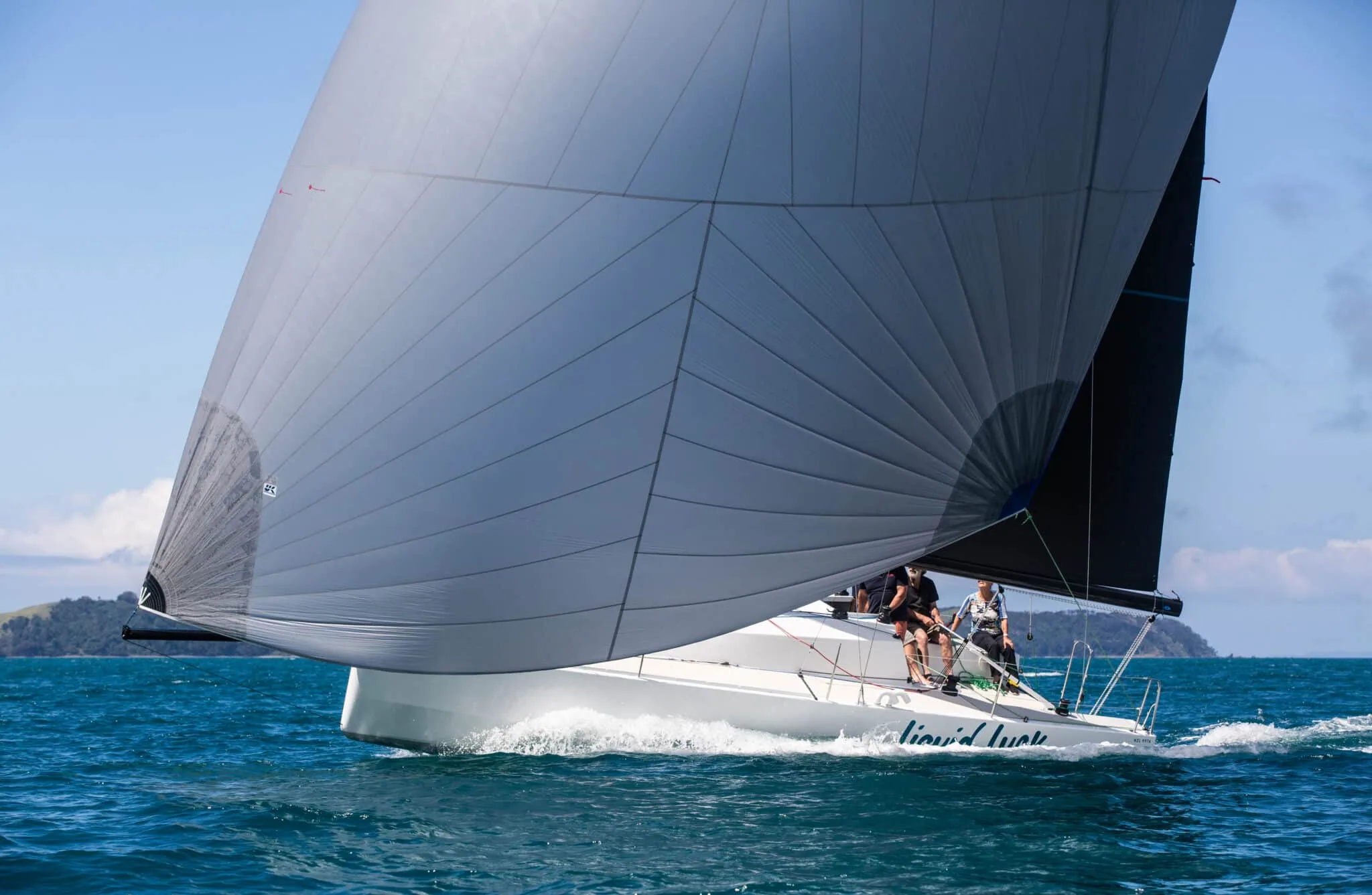 Elliott 30 Liquid Luck reaching under a full Titanium spinnaker off New Zealand