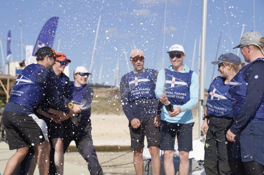 Royal Thames Yacht Club team celebrating with champagne after winning the Cumberland Cup