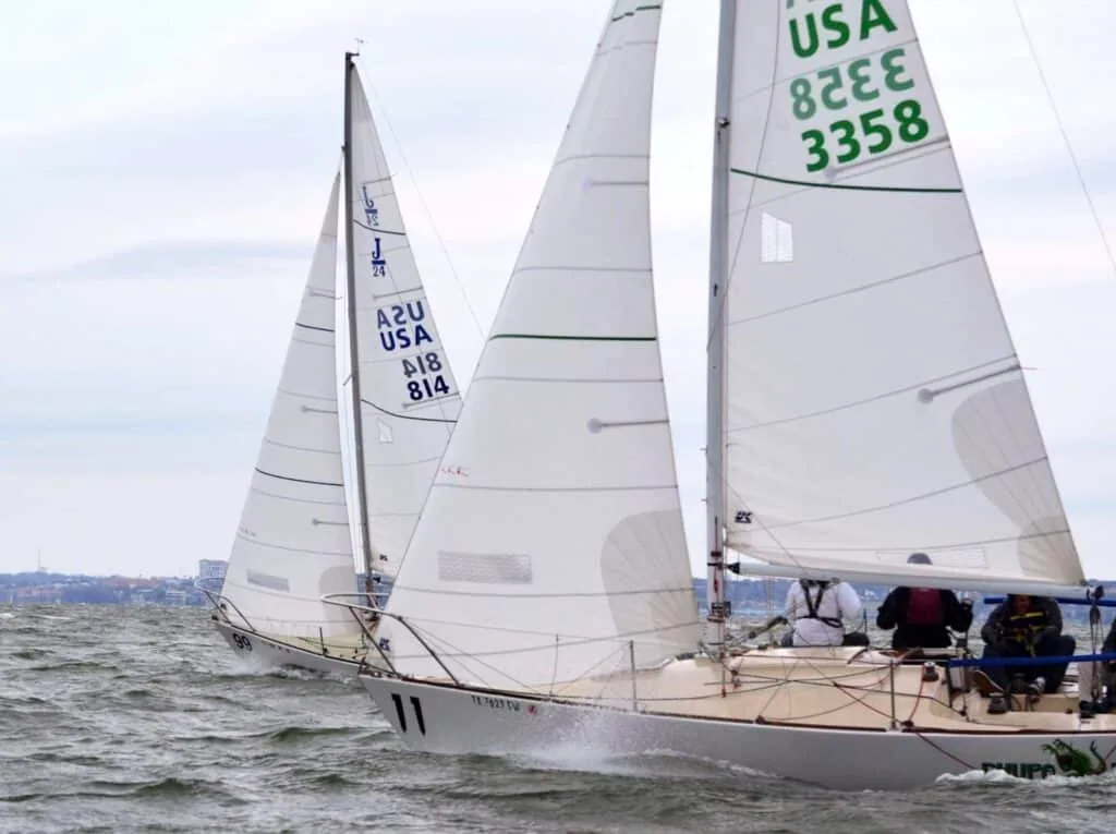 Sailboats USA 3358 and A2U 814 racing close together upwind under white sails