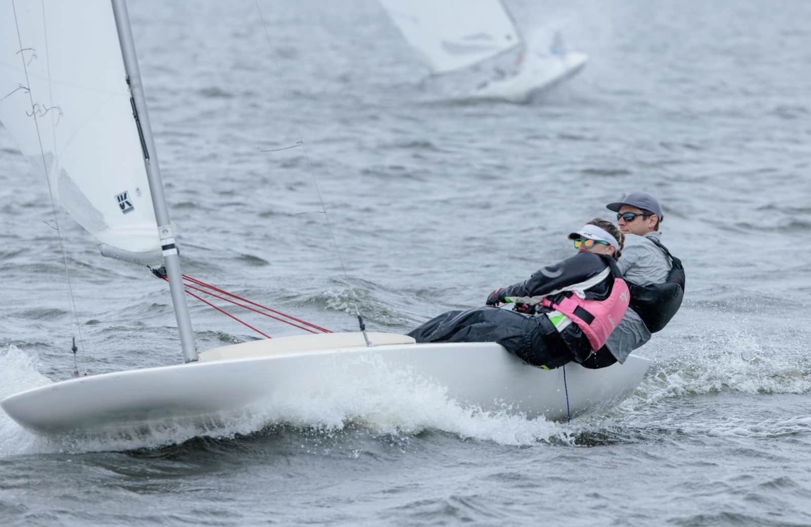 MC Scow crew hiked out reaching upwind at the MCSA National Championship, boats astern