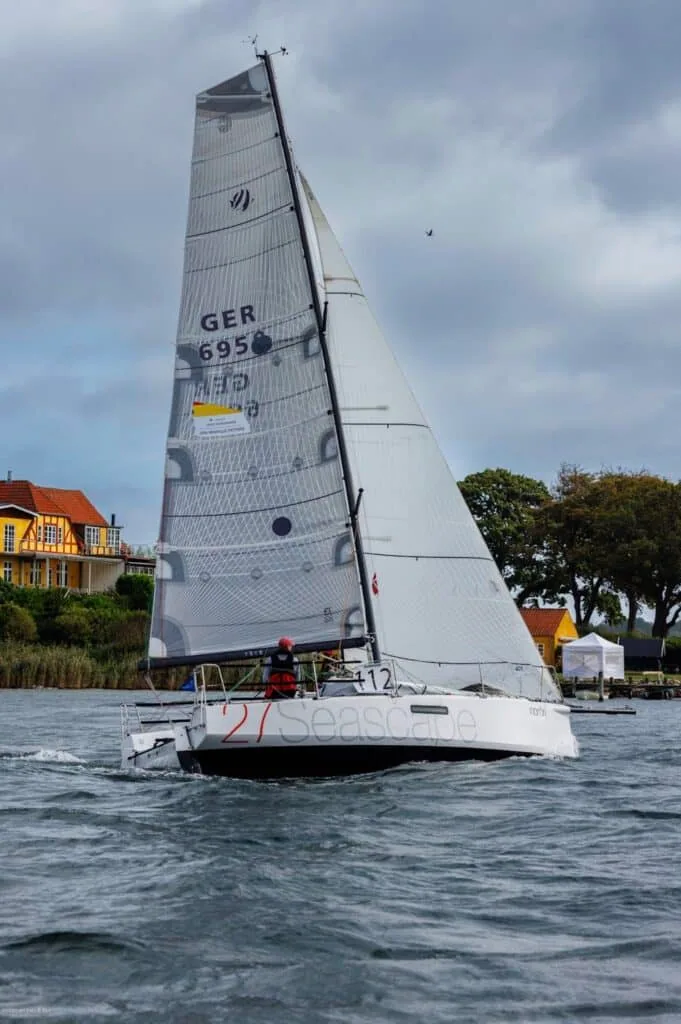 White offshore racer named Seascape reaching under mainsail and jib, sail number GER 695