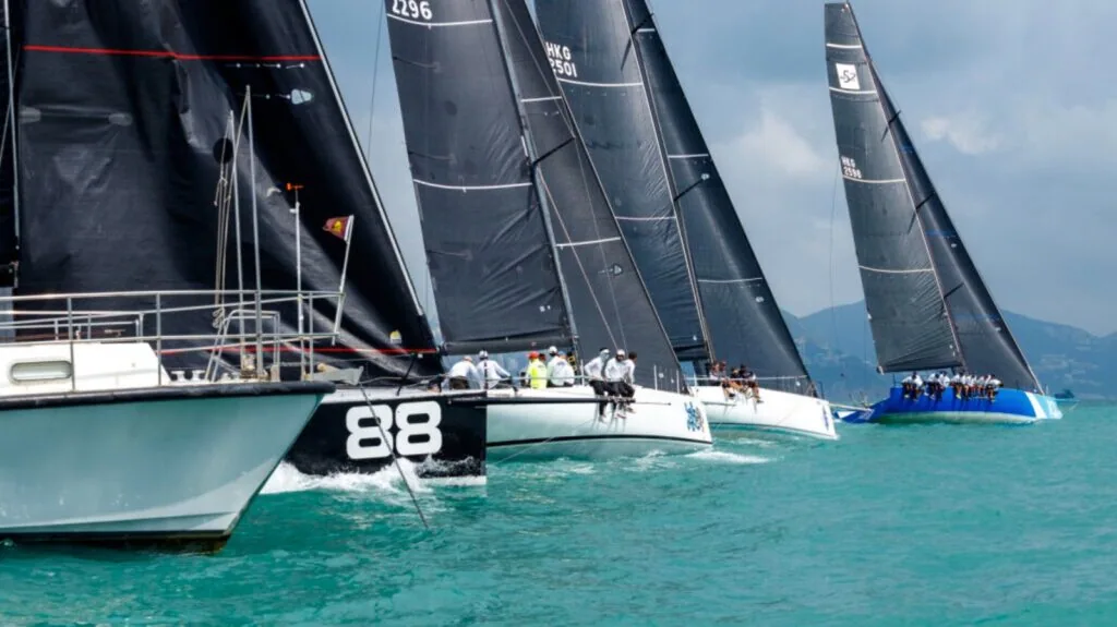 Fleet of black-sailed racers reaching together, boat 88 in the foreground, China Coast Regatta