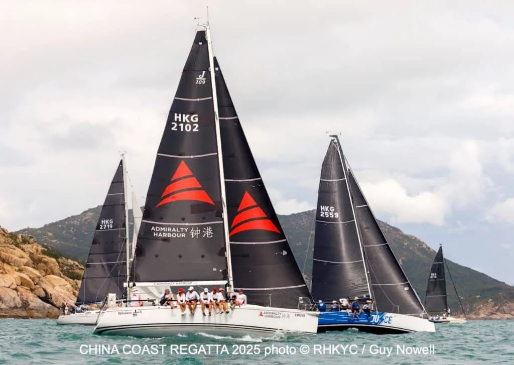 Yacht Admiralty Harbour (HKG 2102) leading fleet past rocky hills at the China Coast Regatta