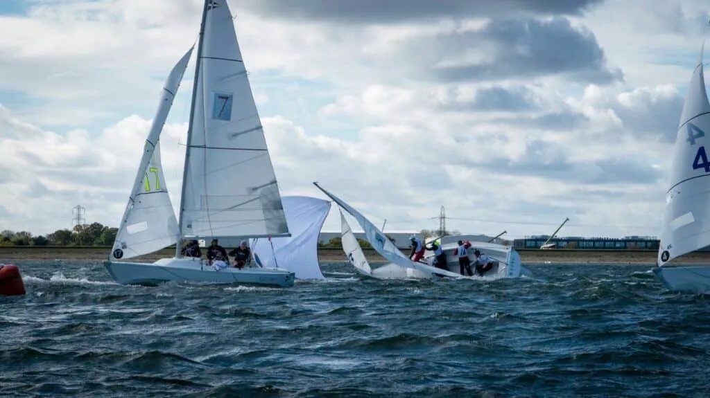 Sonar crew dousing a spinnaker between two overlapping boats at the British American Cup