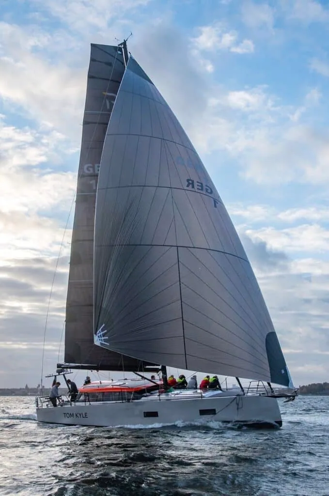 Pure 42 'Tom Kyle' sailing under full dark main and jib with crew on the rail