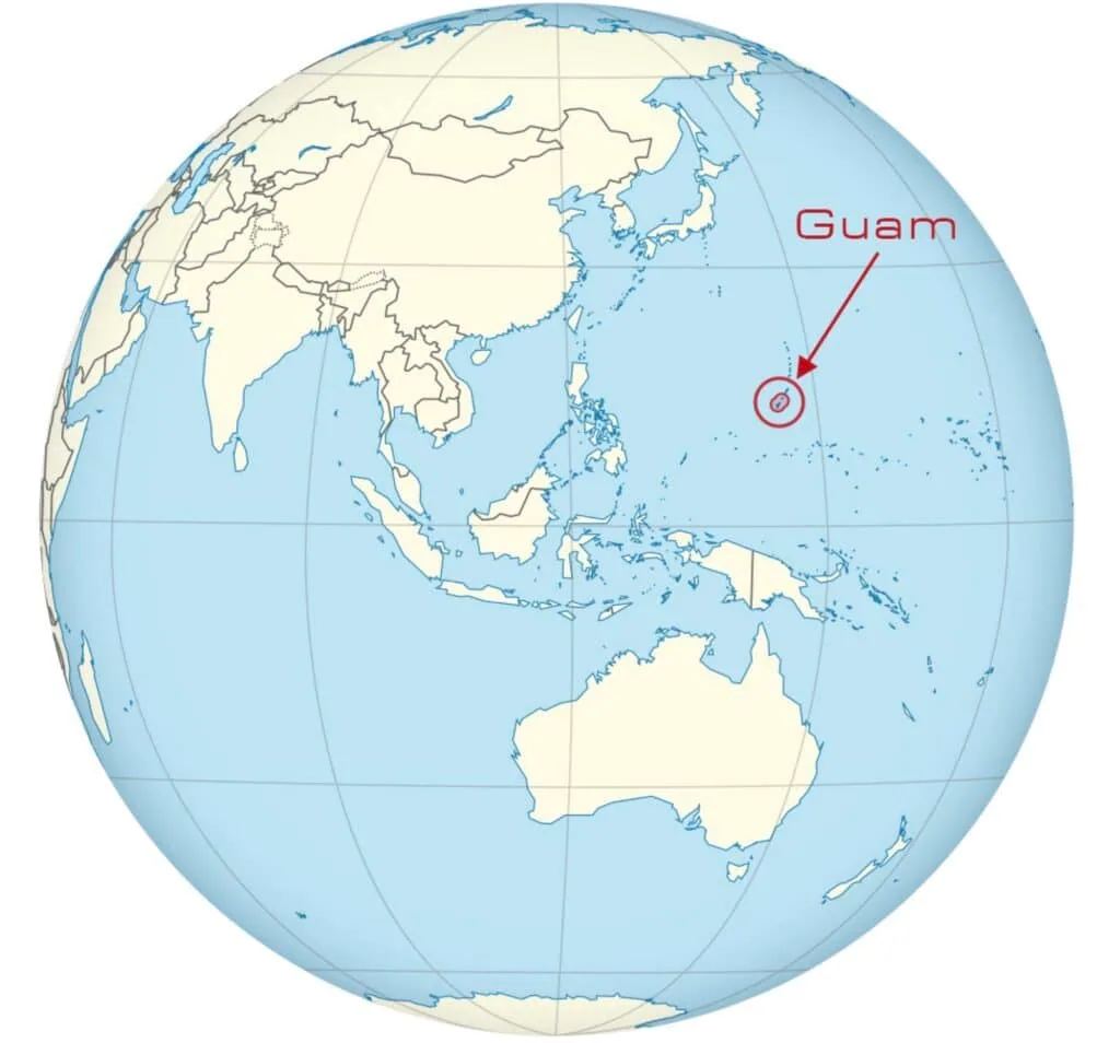 World map globe with Guam circled and labeled in the western Pacific