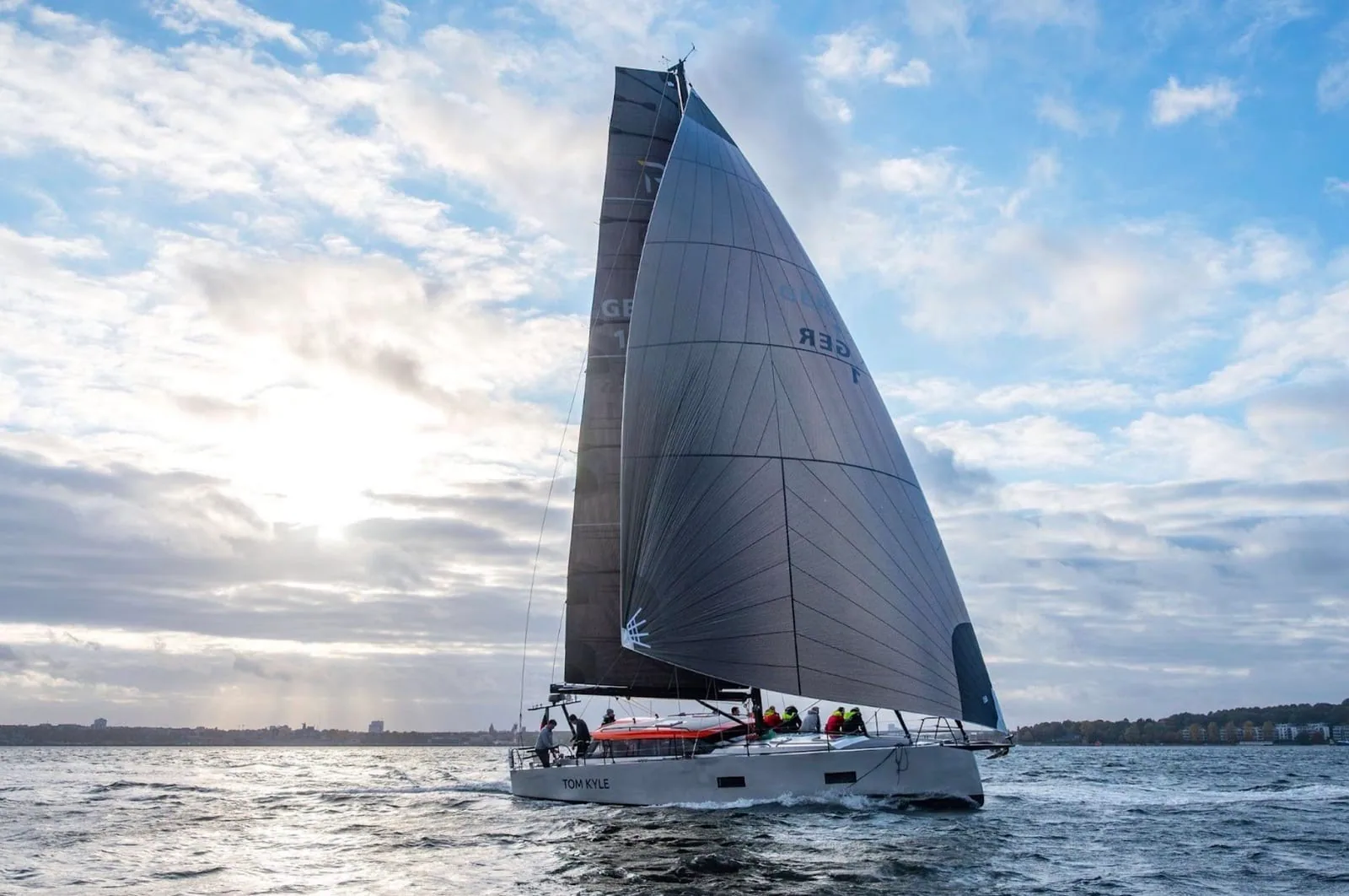 Pure 42 sailing under X-Drive® main and jib, backlit against a bright sky
