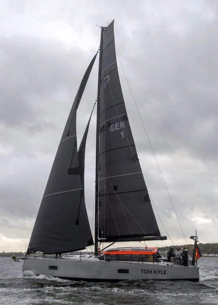 Pure 42 'Tom Kyle' close-hauled under dark sails beneath an overcast sky