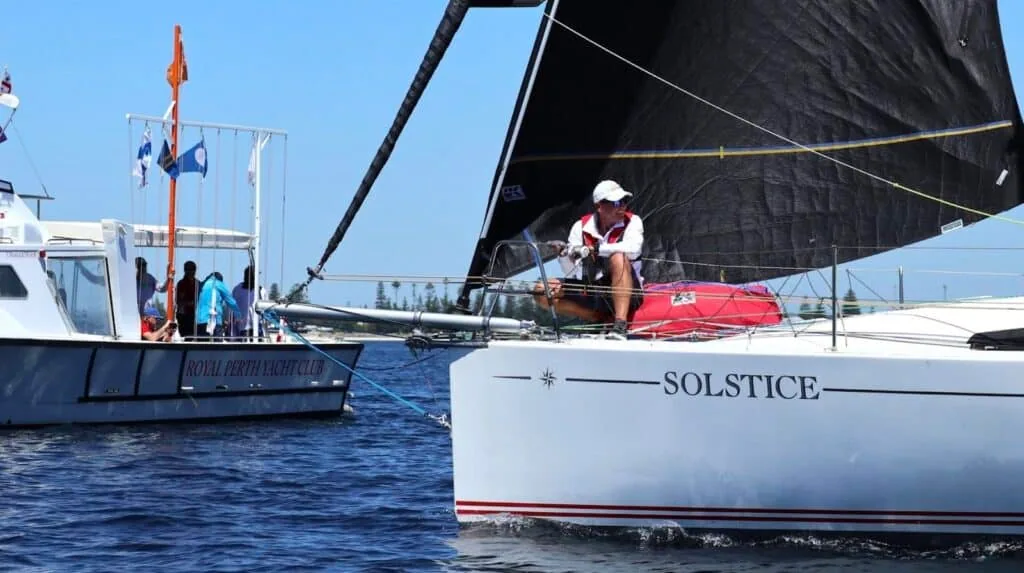 Solstice passing a committee boat near the start line