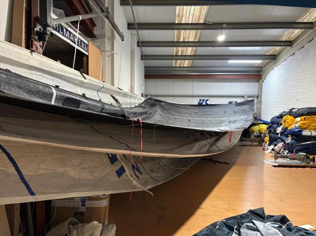 Mainsail draped over a rack inside the UK Sailmakers loft