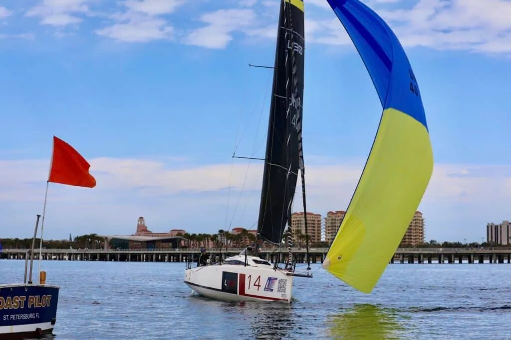 L30 #14 flying a blue-and-yellow kite past the St. Petersburg mark