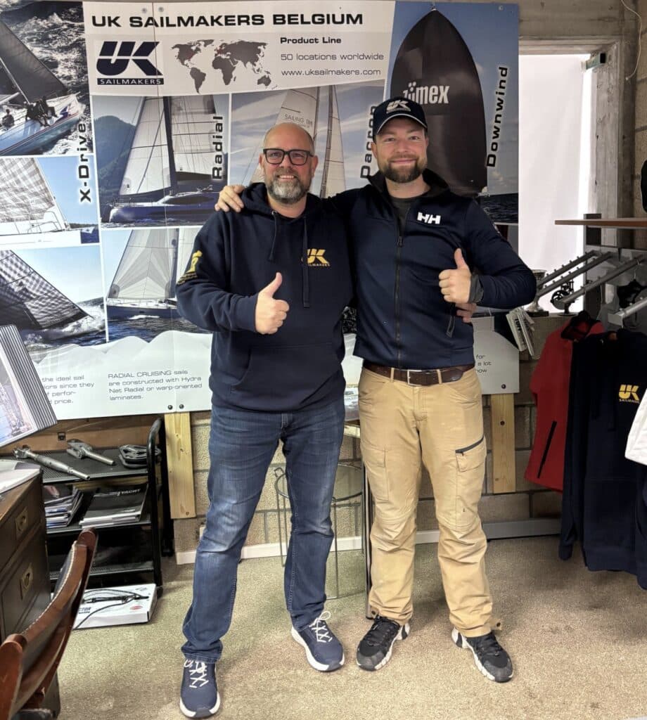 Two UK Sailmakers Belgium staff pose thumbs-up inside the loft