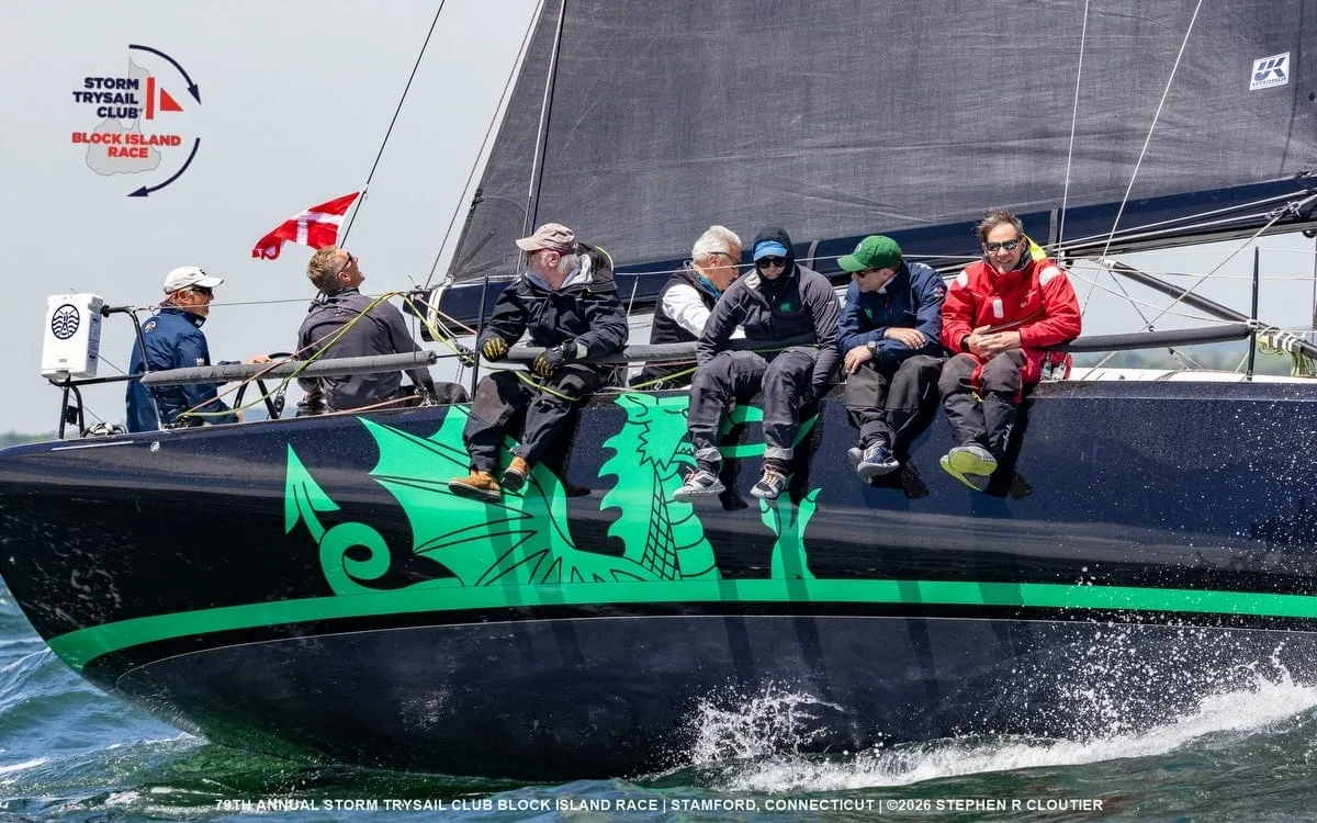 Christopher Dragon's crew hikes out beside its green dragon hull graphic