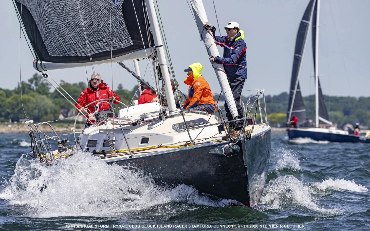 Duet's crew on the rail with spray flying at the Block Island Race