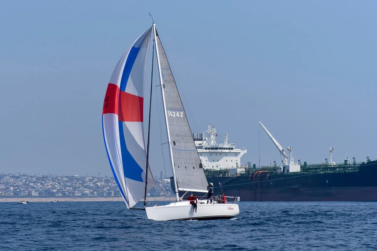 J/109 Feleena sailing downwind under a red, white and blue spinnaker