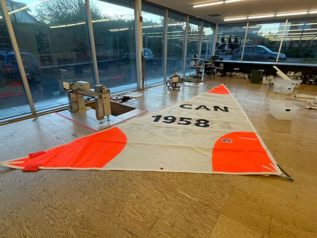 Storm jib CAN 1958 laid out flat on the sail loft floor for inspection