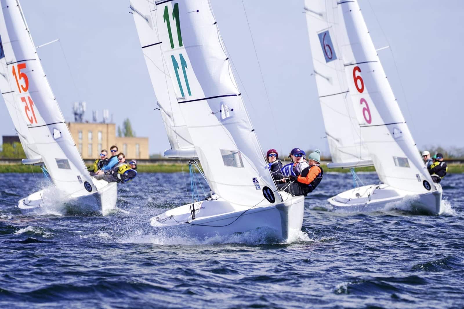 One-design fleet racing upwind with numbered sails at the Carmela Cup