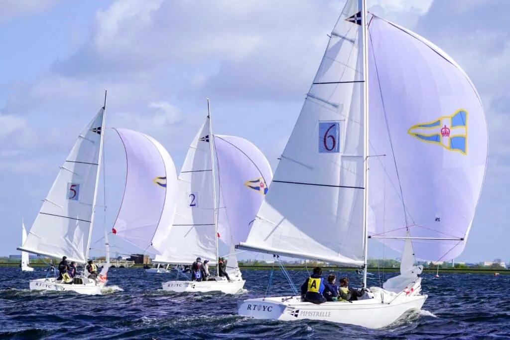 RTYC fleet running downwind under white spinnakers at the Carmela Cup