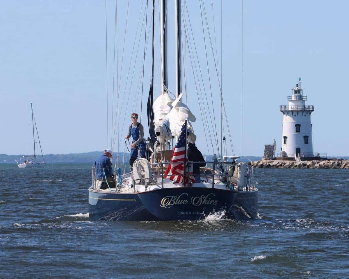Blue Skies of Essex, CT motors past a lighthouse with flag flying