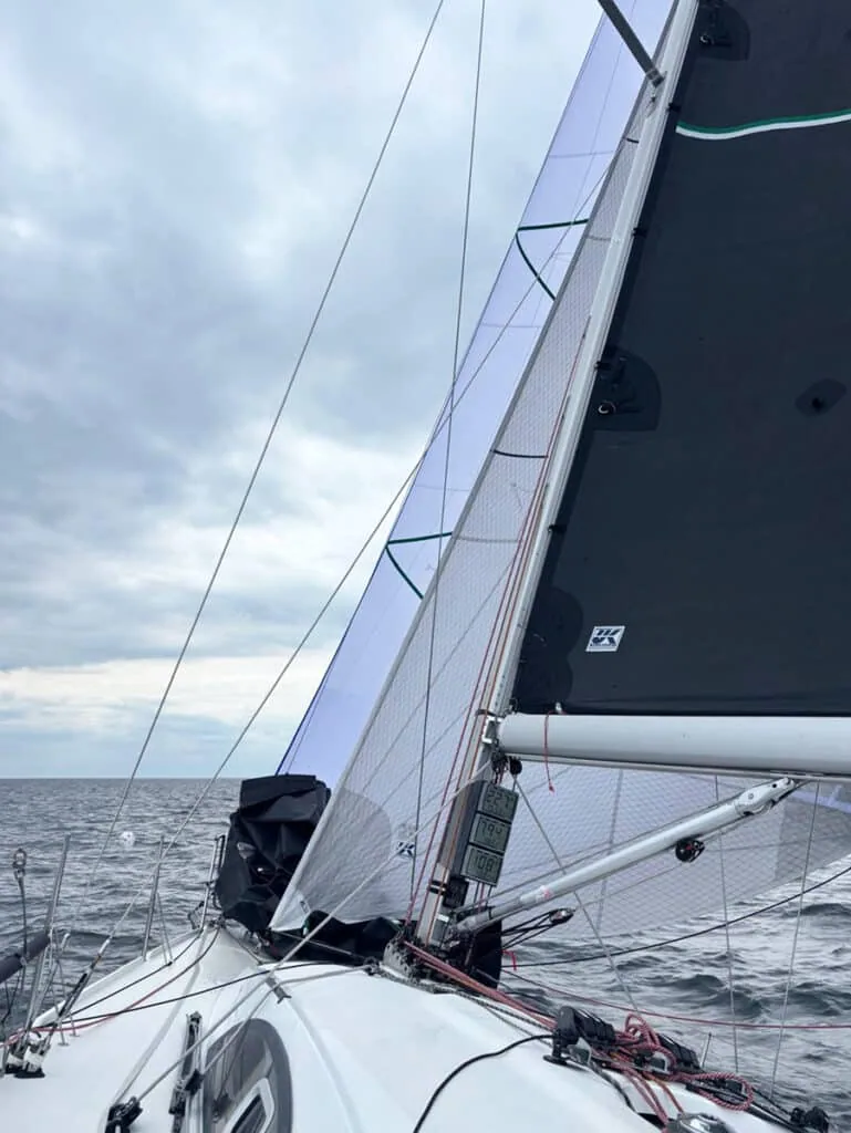 OM sailing under an inner staysail and mainsail in overcast conditions